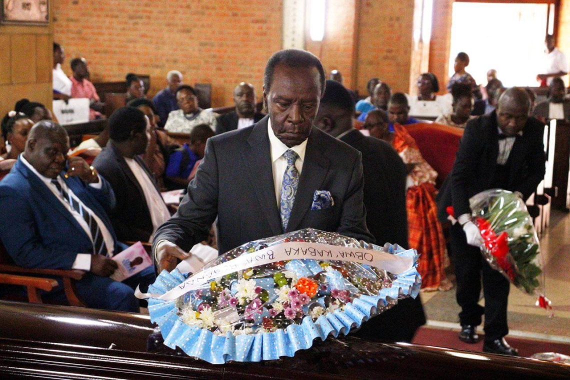 Hon. Patrick Luwaga Mugumbule laying a wreath at the coffin of the deceased Hon. Patrick Luwaga Mugumbule laying a wreath at the coffin of the deceased